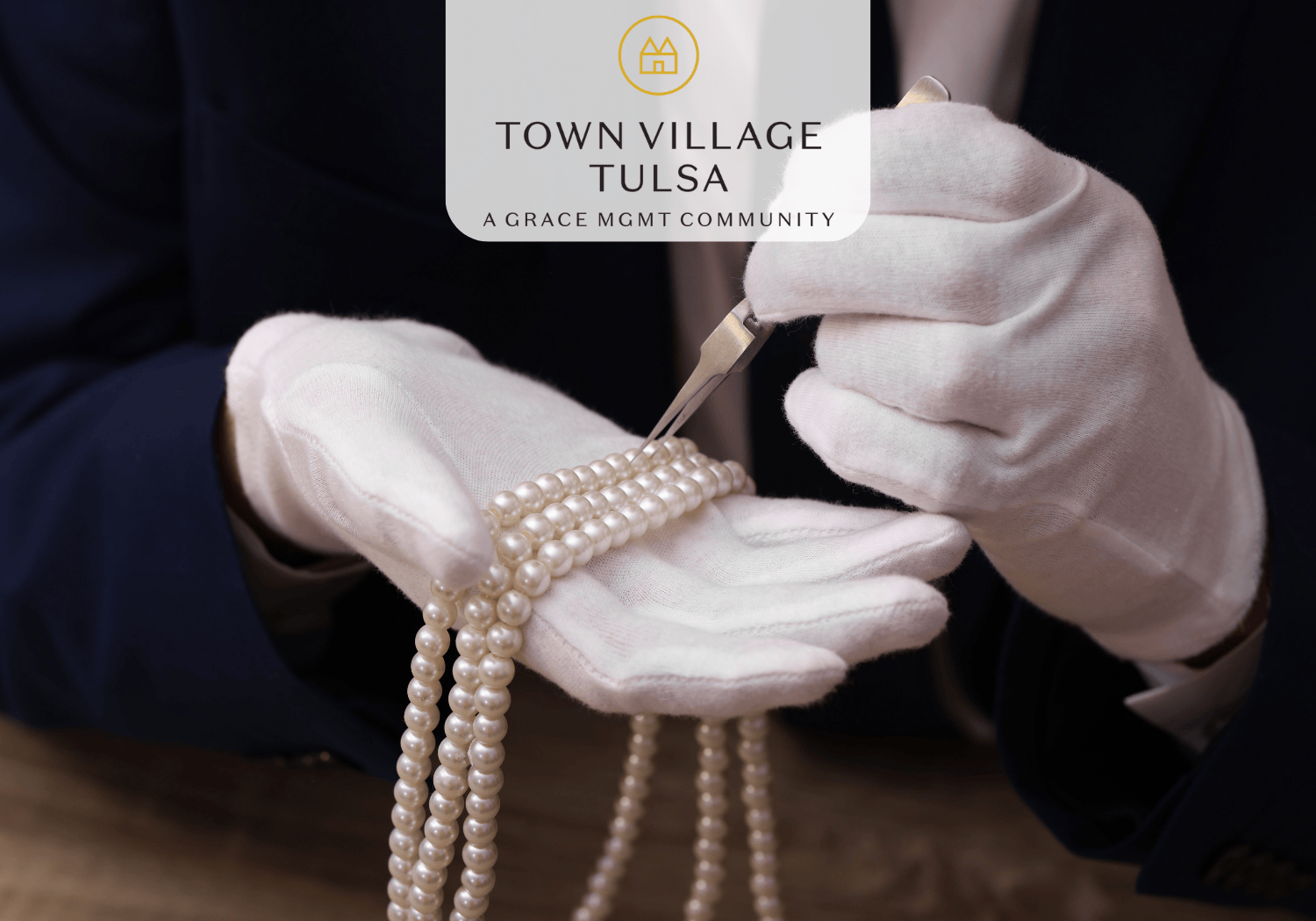 person with white gloves holding a pearl neckalace